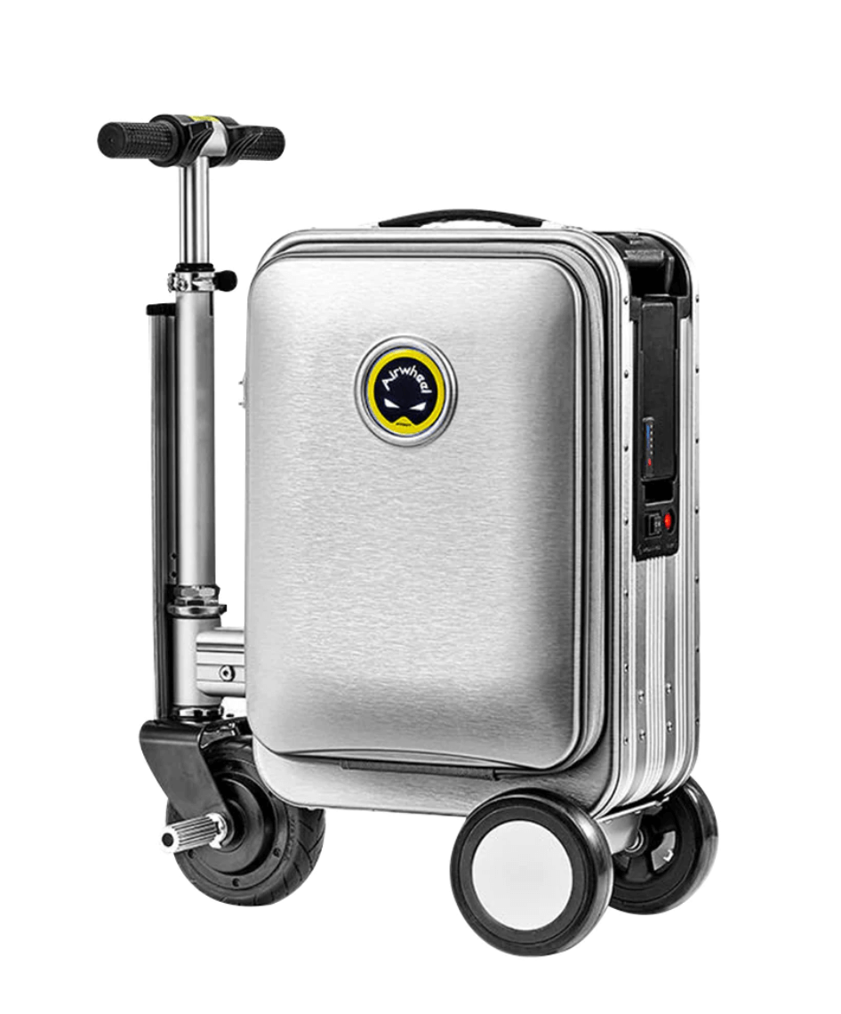 A silver Airwheel SE3S smart suitcase with an integrated handlebar and wheels, designed for riding. The suitcase features the Airwheel logo on the front and is equipped with a compact electric motor for easy mobility