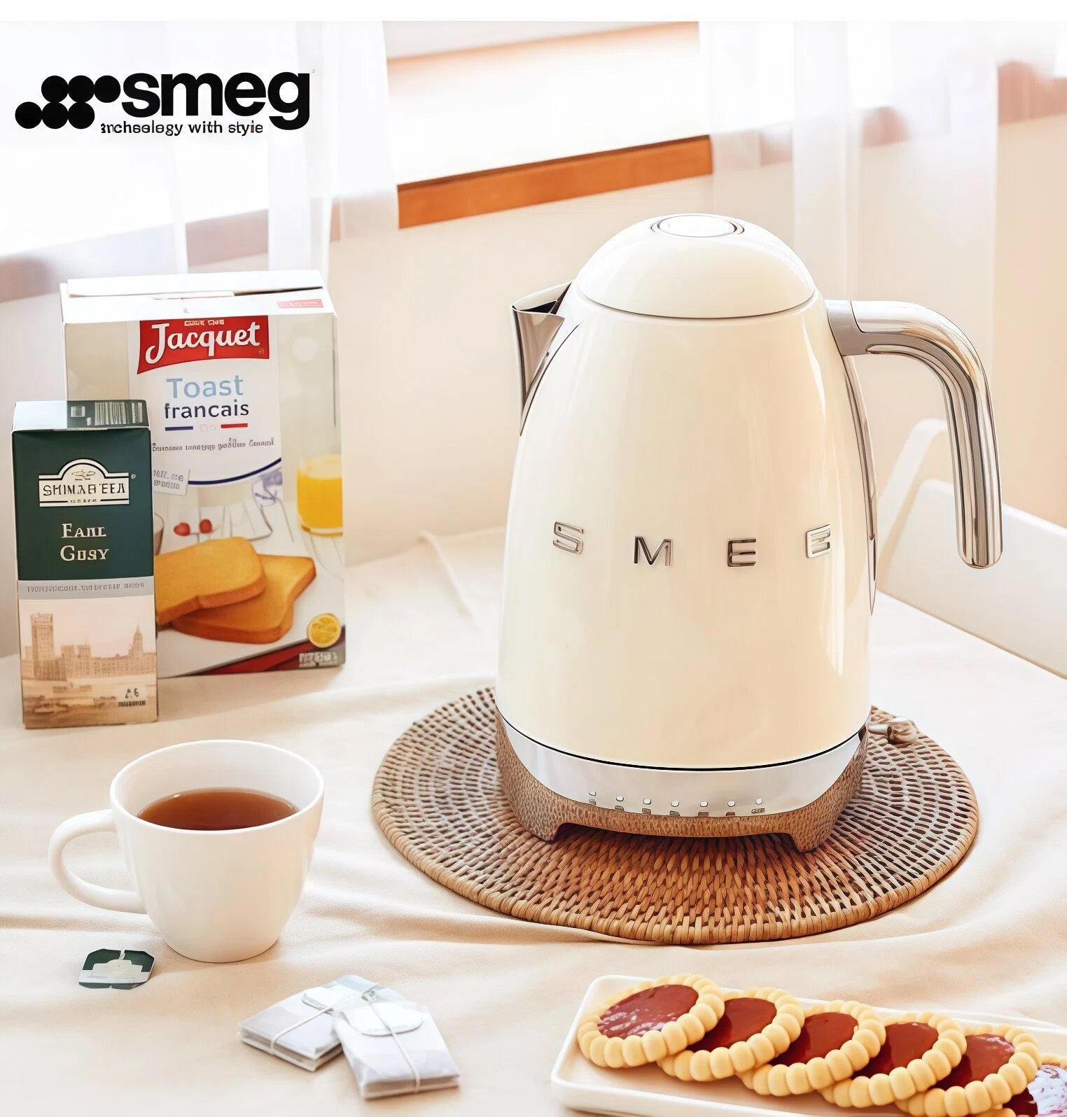 The iconic cream Smeg KLF04 Variable Temperature Kettle sitting on a wicker placemat as part of a cozy breakfast scene, perfect for brewing the ideal cup of tea.