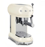 The iconic Smeg 50's Style Espresso Coffee Machine (ECF02WHAU) in a retro cream finish, shown from a front-three-quarters angle with its portafilter in place on a clean white background.