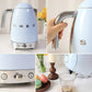 A collage of the Smeg KLF04 kettle in pastel blue, showing detailed close-ups of the ergonomic handle, the variable temperature control knob, and its smooth pouring action.