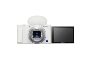 Side view of the white Sony ZV-1 camera with 180° flip-out LCD screen and included furry windscreen for clear outdoor audio recording.