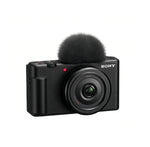 Front view of black Sony ZV-1F 4K vlog camera with 20 mm f/2.0 Zeiss lens and windscreen.
