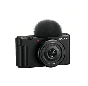 Front view of black Sony ZV-1F 4K vlog camera with 20 mm f/2.0 Zeiss lens and windscreen.