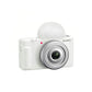 Front view of white Sony ZV-1F 4K vlog camera featuring 20 mm f/2.0 Zeiss lens and built-in windscreen.