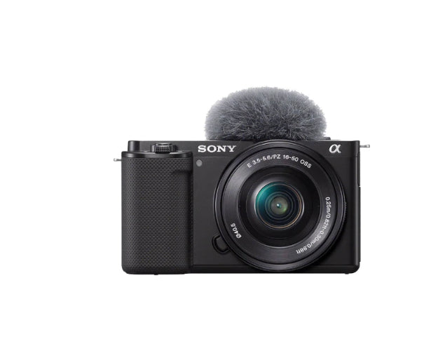 Front view of black Sony ZV-E10 mirrorless vlog camera with 16-50 mm lens and included windproof microphone.