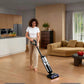 A woman is cleaning a large open-plan home with the Tineco FLOOR ONE S7 Stretch SteamFree, highlighting its ultra-long runtime of up to 80 minutes on a single charge for whole-house cleaning.