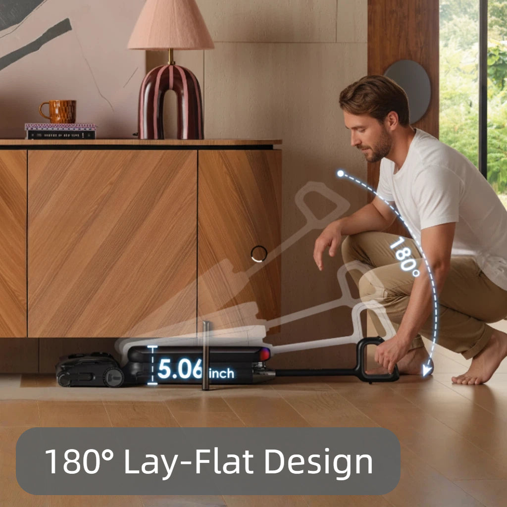 A person easily cleaning under low furniture with the Tineco FLOOR ONE S9 Artist Pro, demonstrating its 180-degree lay-flat capability that reaches spaces as low as 5.06 inches.[
