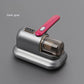 Image of a compact handheld vacuum cleaner in a dark grey and majenta color scheme. The vacuum features a transparent dustbin and a simple control panel on top of the handle. The design is sleek and minimalistic, suitable for efficiently cleaning small areas or furniture