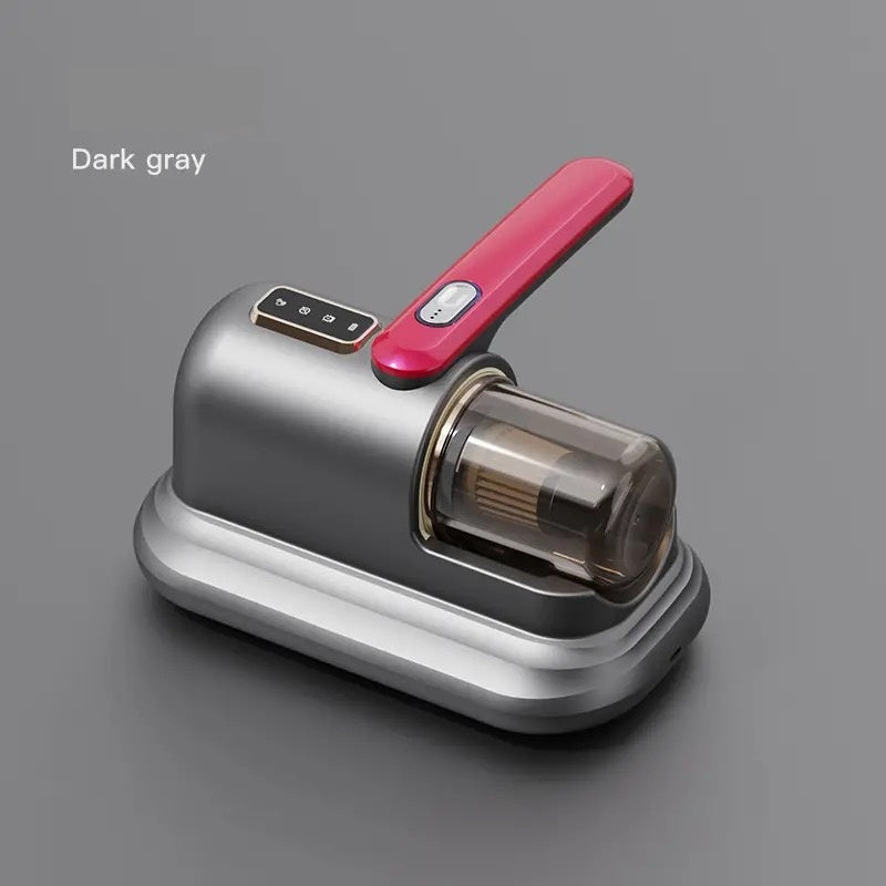 Image of a compact handheld vacuum cleaner in a dark grey and majenta color scheme. The vacuum features a transparent dustbin and a simple control panel on top of the handle. The design is sleek and minimalistic, suitable for efficiently cleaning small areas or furniture