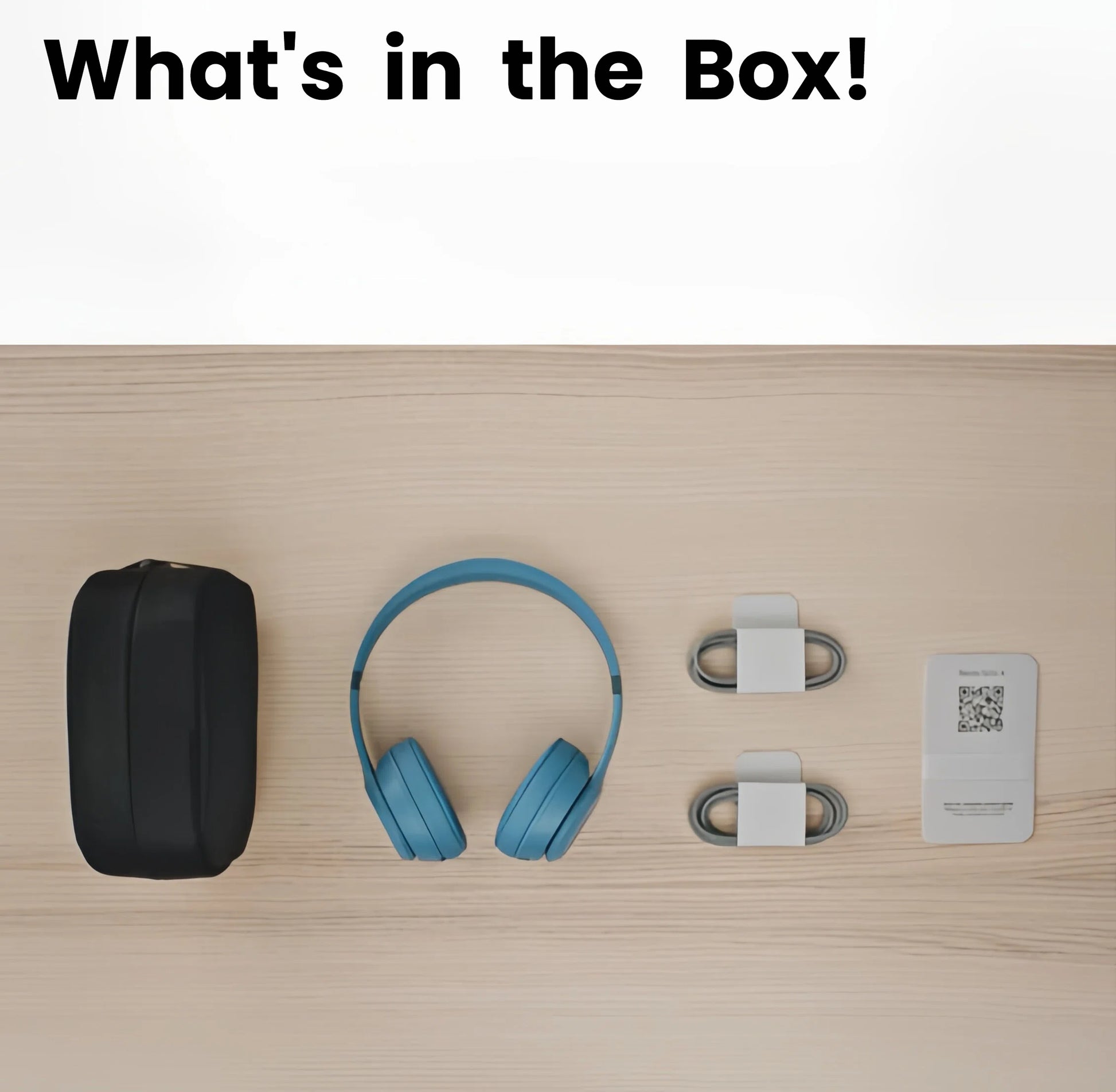 All the items included in the Beats Solo 4 box laid out on a table: the headphones, carrying case, USB-C charging cable, and 3.5mm audio cable