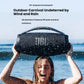 A woman holding the JBL Boombox 3 speaker at the beach, demonstrating its IP67 waterproof and dustproof rating for outdoor use without worry.