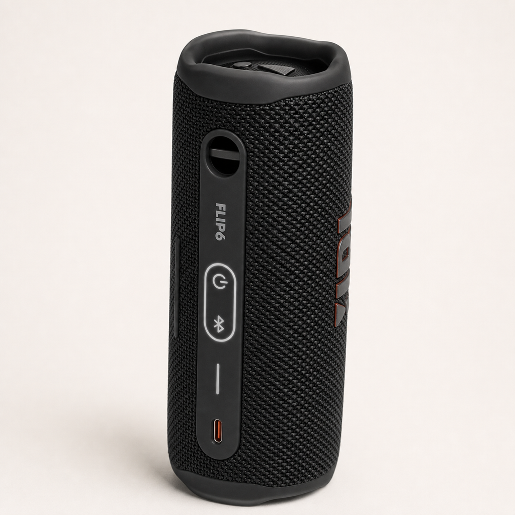 JBL Flip 6 black speaker standing vertically with top control panel