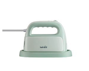The Keheal portable handheld garment steamer in a light mint green color, shown from the side while resting on its protective heat-resistant base.