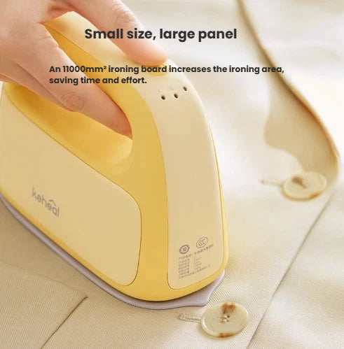 A close-up of the yellow Keheal portable steam iron easily smoothing wrinkles on a jacket, highlighting its large 11000mm² panel for efficient ironing.