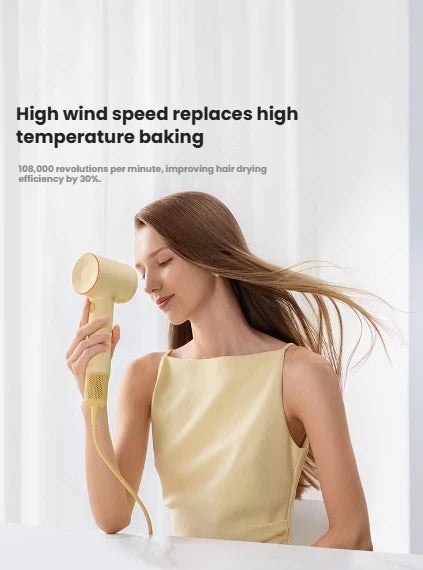 A woman using the yellow Laifen SE 2 to demonstrate how its high wind speed from the 108,000 RPM motor replaces high-temperature baking for improved drying efficiency