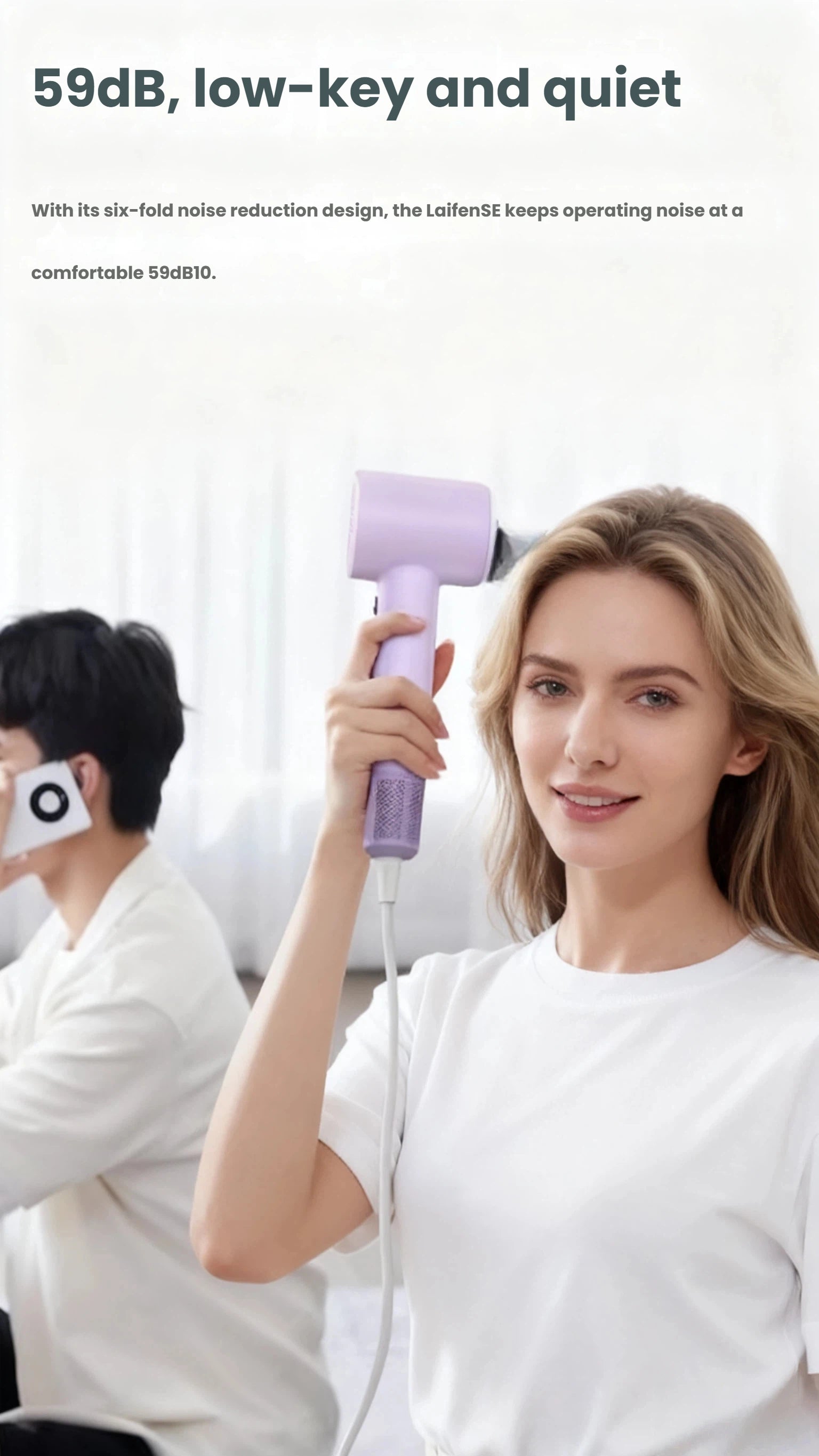 A woman comfortably using the purple Laifen SE hair dryer, highlighting its low-key and quiet operation at only 59dB.