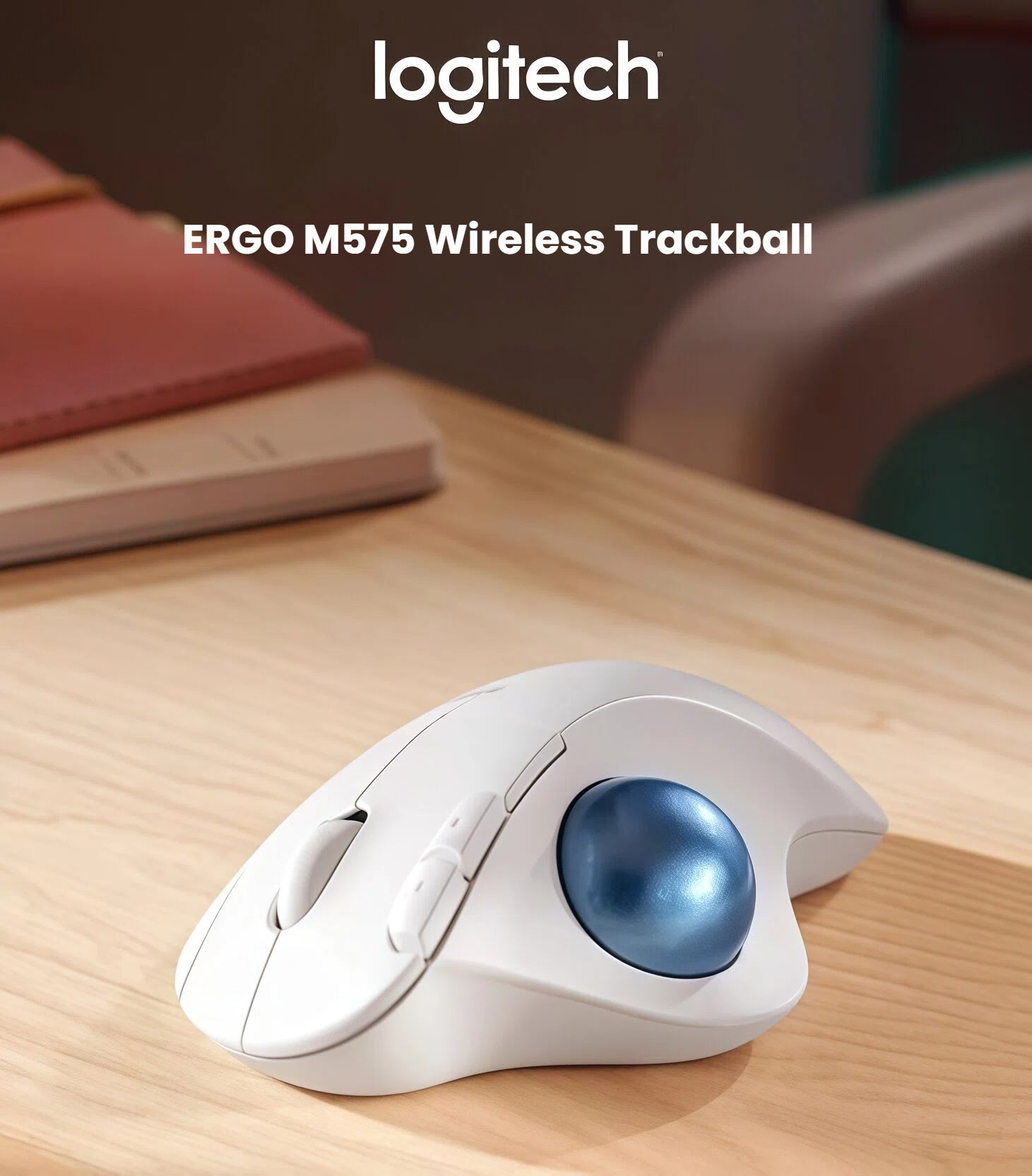  Close-up of the white Logitech M575S wireless mouse on a wooden desk, highlighting the sculpted ergonomic shape and the precision blue trackball controller.