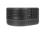 Top-down view of the graphite Logitech Wave Keys wireless ergonomic keyboard, featuring a wave-shaped key layout and integrated cushioned palm rest.
