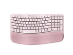 Top-down view of the rose pink Logitech Wave Keys wireless keyboard, highlighting the soft fabric wrist rest and unique wave curvature.