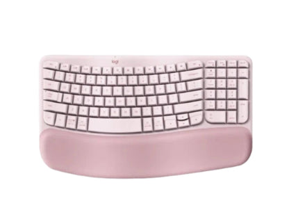 Top-down view of the rose pink Logitech Wave Keys wireless keyboard, highlighting the soft fabric wrist rest and unique wave curvature.