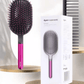 Image of a hair care set featuring a wide paddle brush with a curved design and pink handle, alongside a black wide-tooth comb. The brush has a flexible, ventilated structure with rounded bristles for gentle detangling, while the comb, labeled with the 'Dyson' logo, is designed for precise styling and easy detangling of wet or dry hair.
