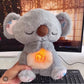 Video of the breathing koala plushie, soft and grey colour with a pink light in the tummy area. Makes relaxing sounds that soothe anxiety and appears to be fluffy and soft. Also makes breathing motion and there is a yellow light n the centre with music 